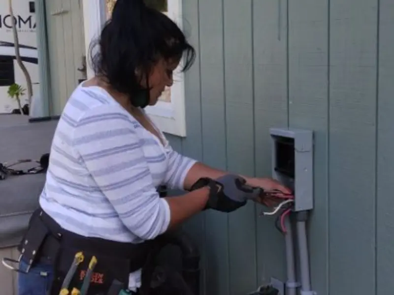 Licensed electrician wiring an exterior subpanel in Montgomery